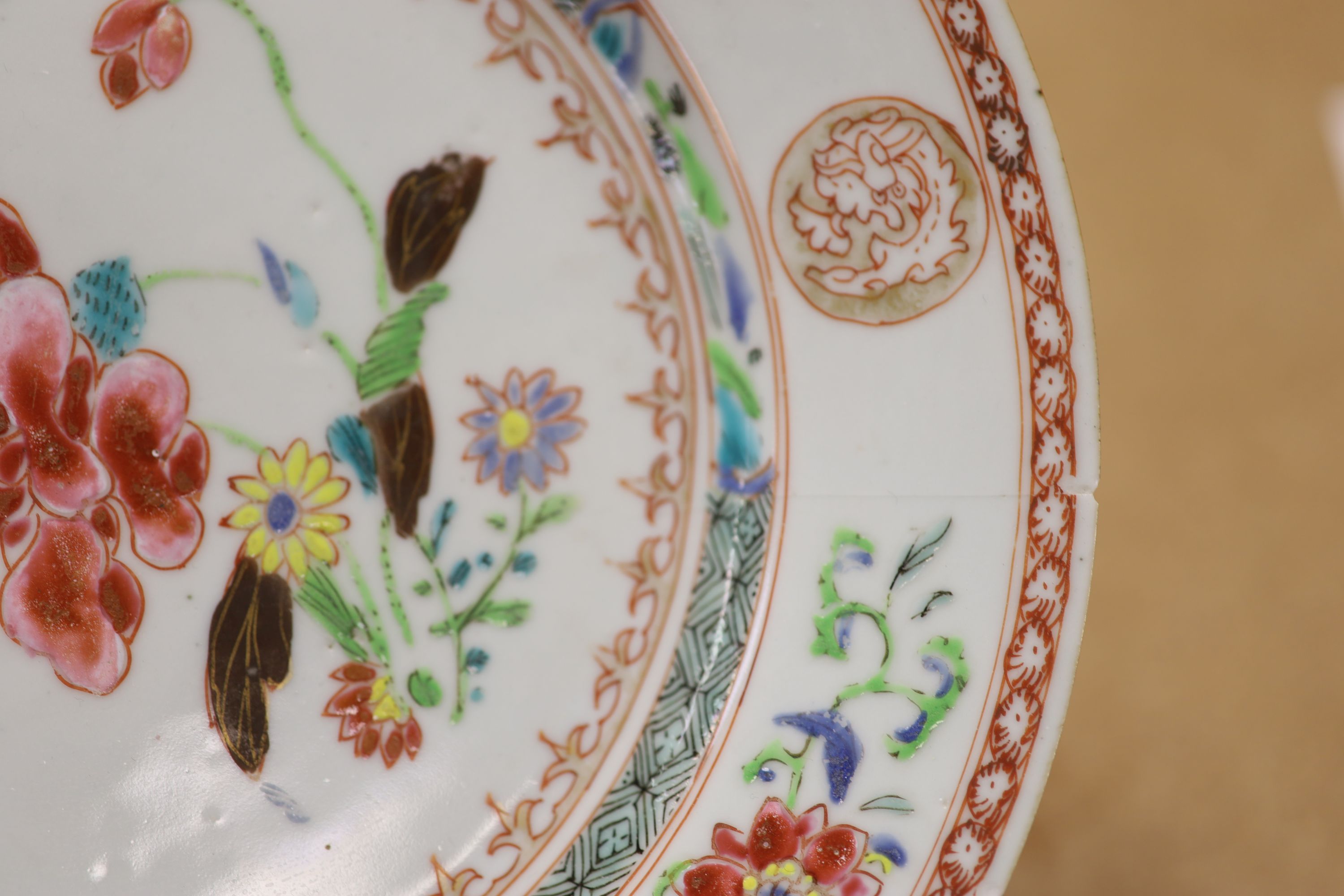 A pair of 18th century Chinese famille rose plates and another similar, largest diameter 22.5cm (damage)